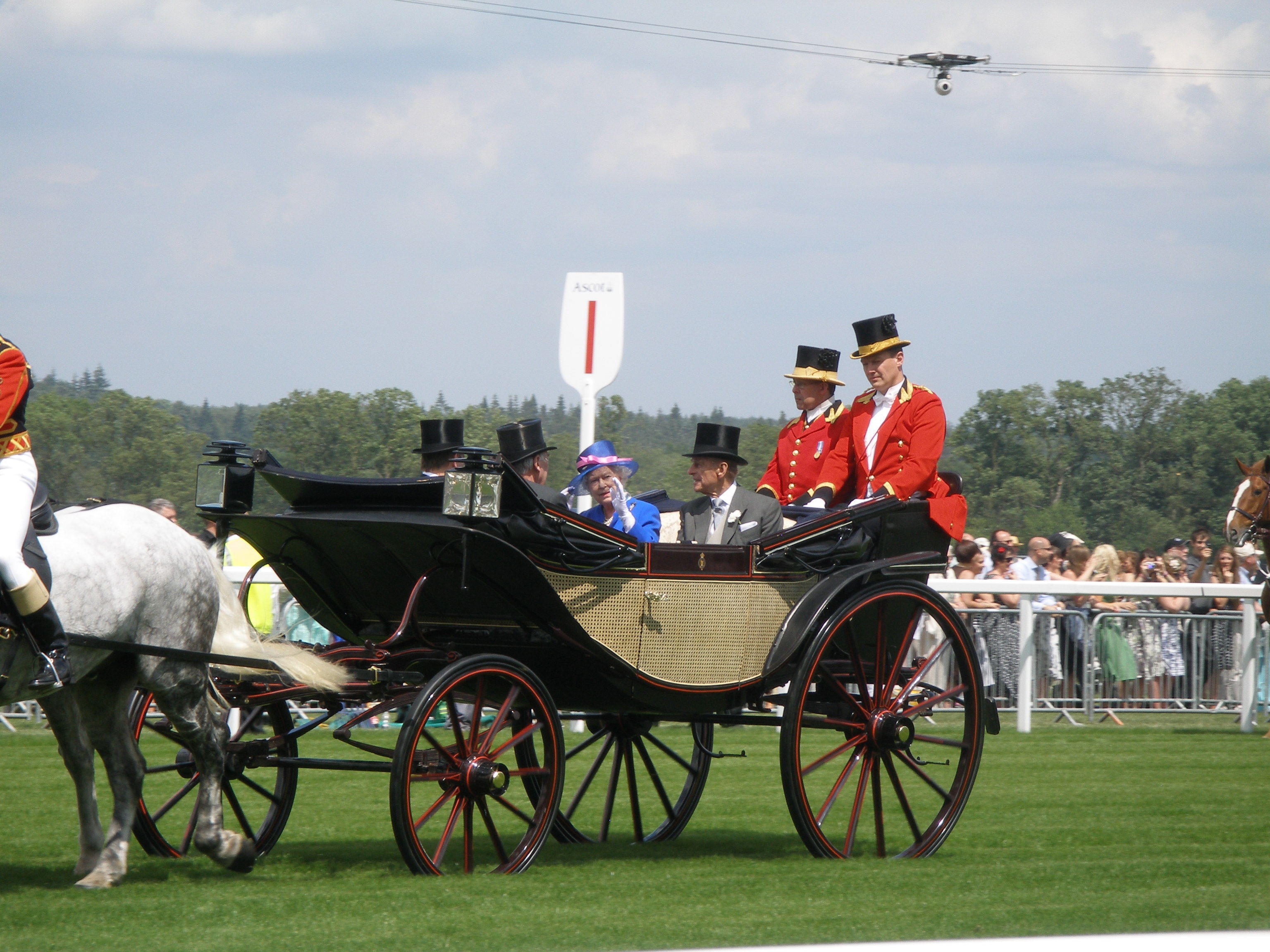 Royals waving in a carrage